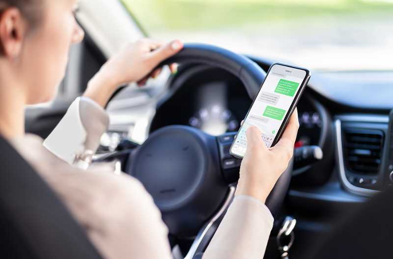 Using phone while driving representing distracted driver